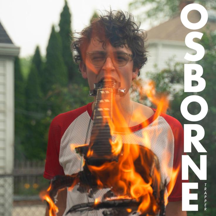 The cover of Trapper Schoepp's album Osborne, featuring a picture of Trapper with a flaming guitar in his mouth.
